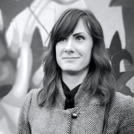 Black and white headshot of a womain with long straight hair.